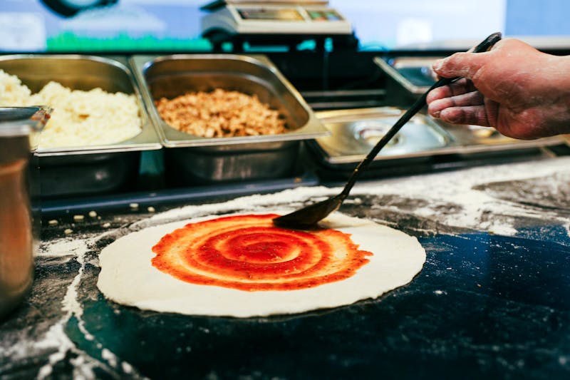 Jet's Pizza kitchen team preparing fresh pizzas